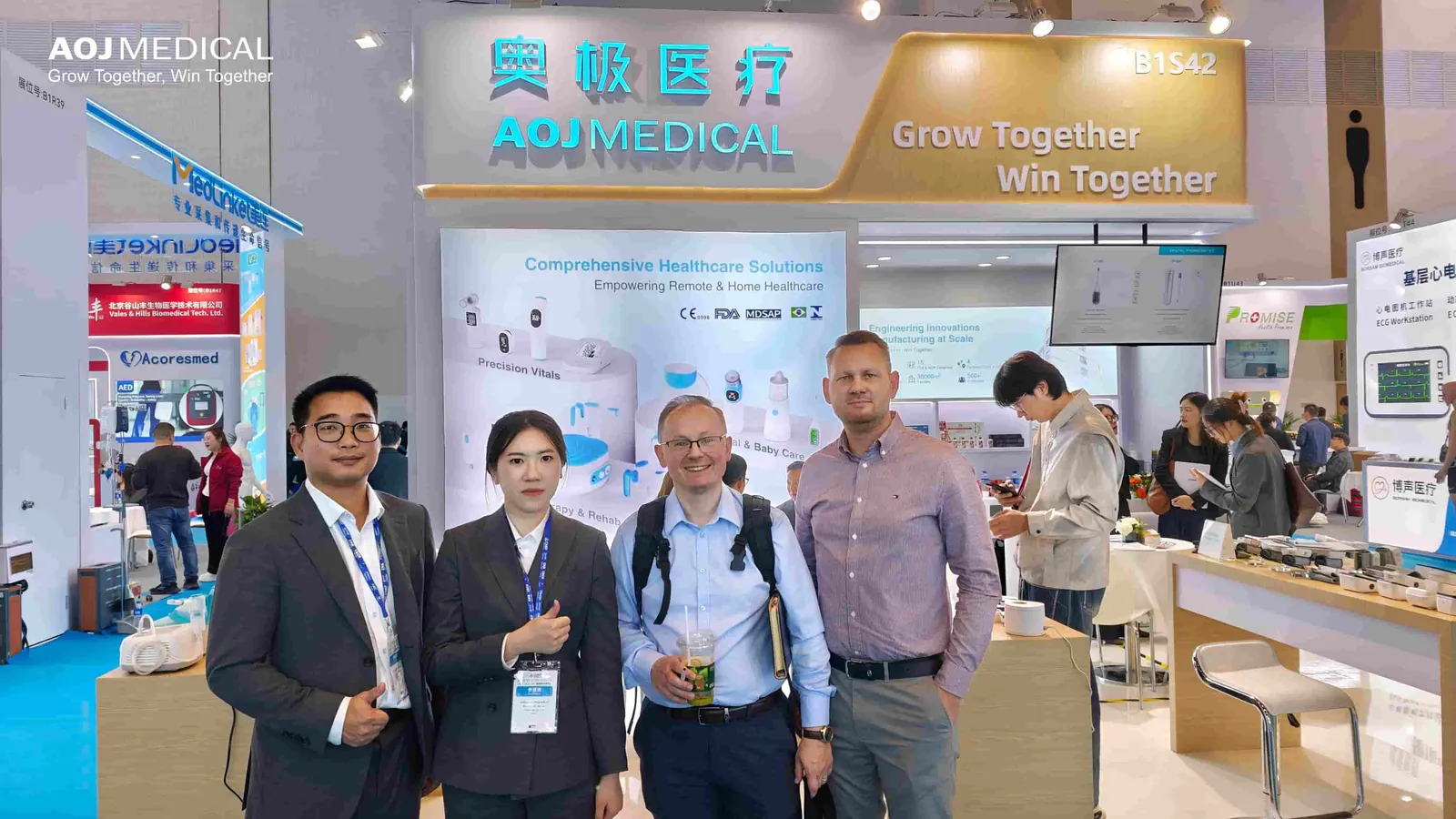 The AOJ Medical team with a visiting partner at Booth B1S42, CMEF Beijing 2026